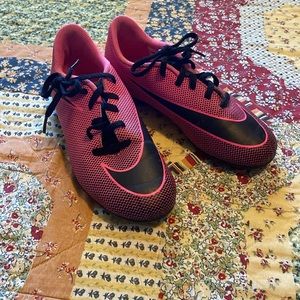 Pink and black Nike athletic shoes with cleats